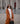 Woman in brown coat and sunglasses